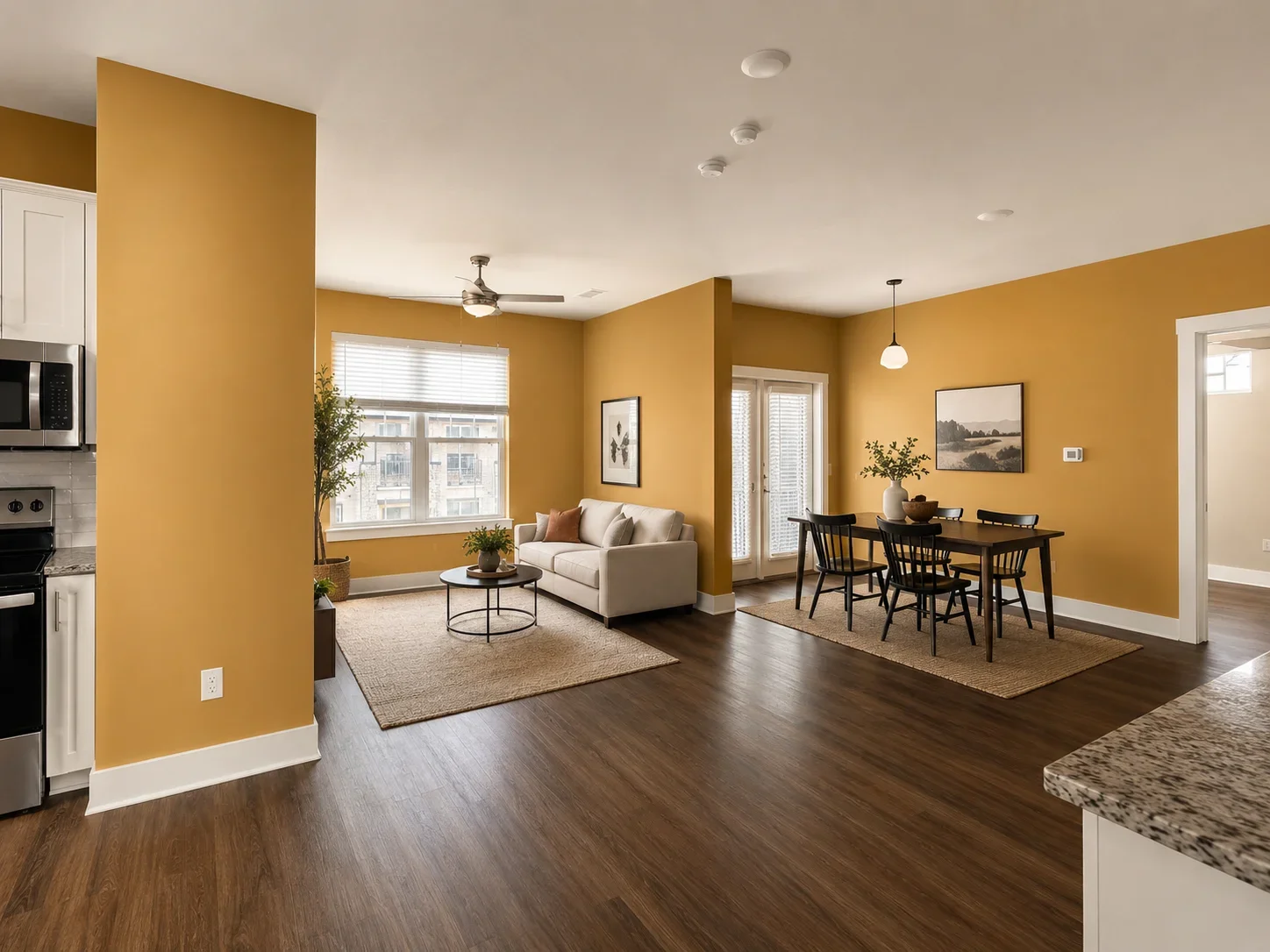 Golden-yellow painted walls in open-concept living area with white trim and ceiling